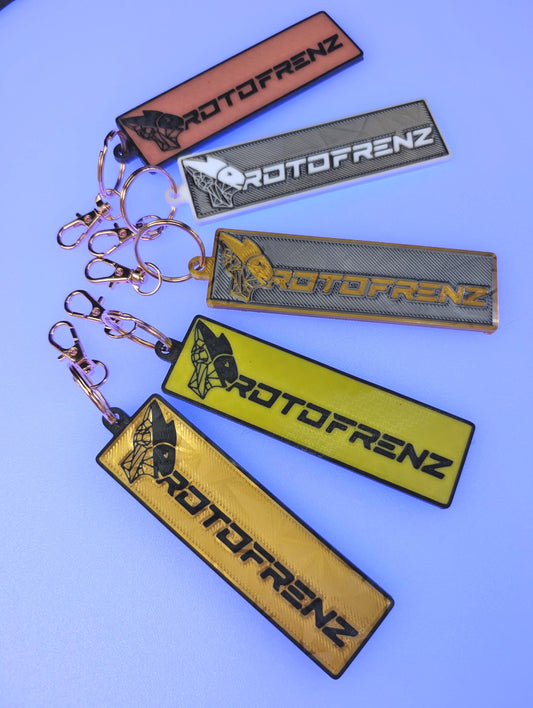 ProtoFrenz logo keychain with lobster claw clip attacher, shown on neutral background
